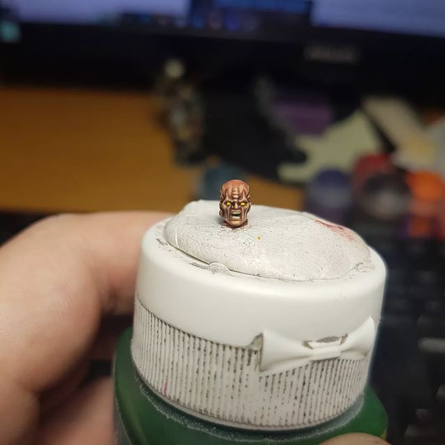 miniature head on a paint bottle